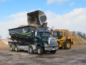 Landscape Organix reduces the cost of precision placement services by using the Stone Slinger to deliver material and reload the blower trucks.