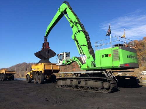 The 875 is fitted with a 14 yd. bucket to transfer coal to trucks from as many as 6 jumbo barges in a day.